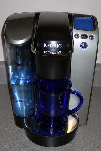 Sleek black coffee maker in home kitchen.